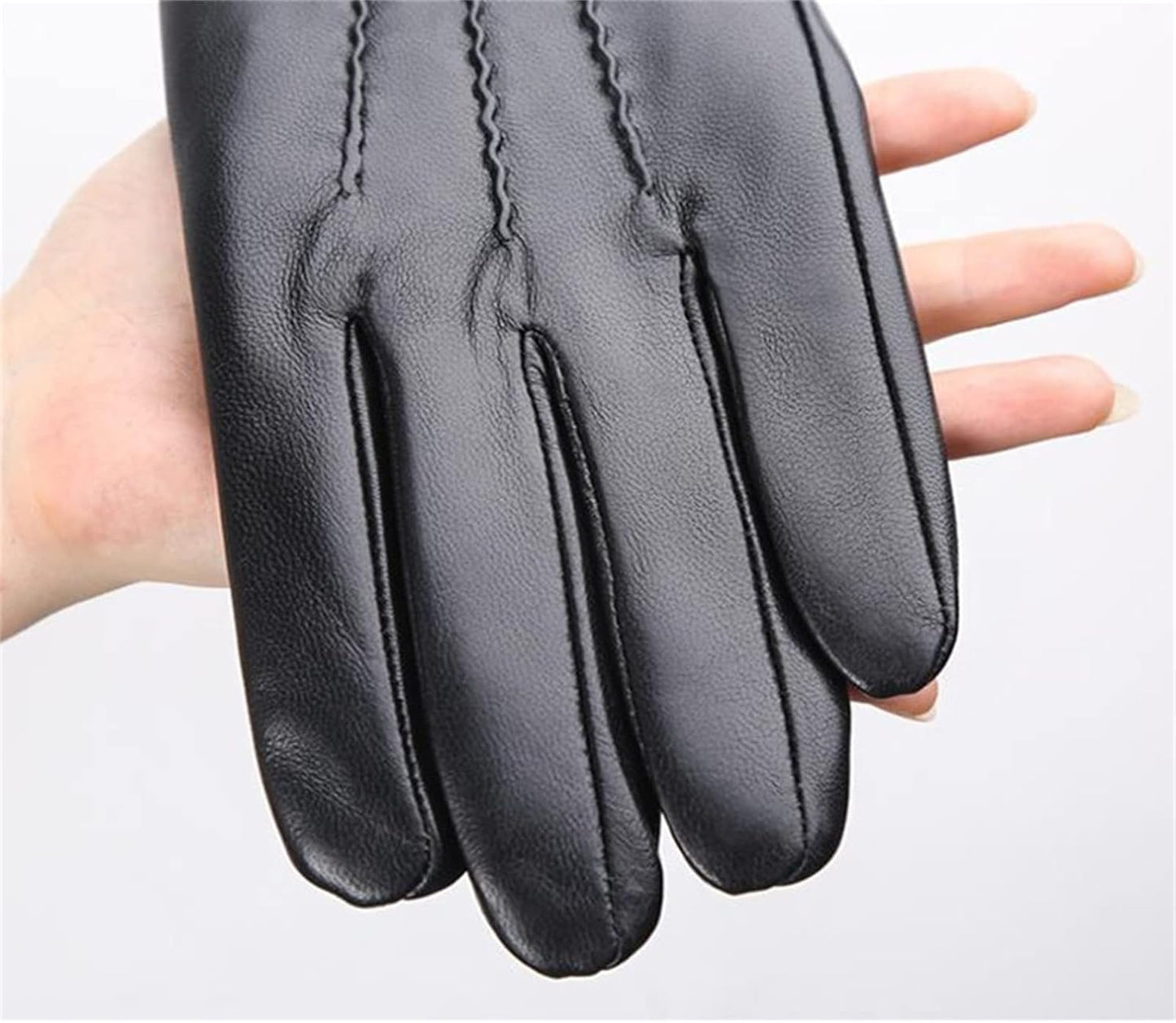 Black Fitlybuy RippleWarm sheepskin winter glove held in hand, featuring elegant ripple-stitch detailing.