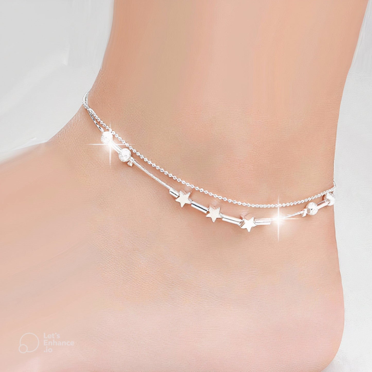 Fitlybuy Sophie silver double-chain anklet with star charms and adjustable clasp worn on an ankle.