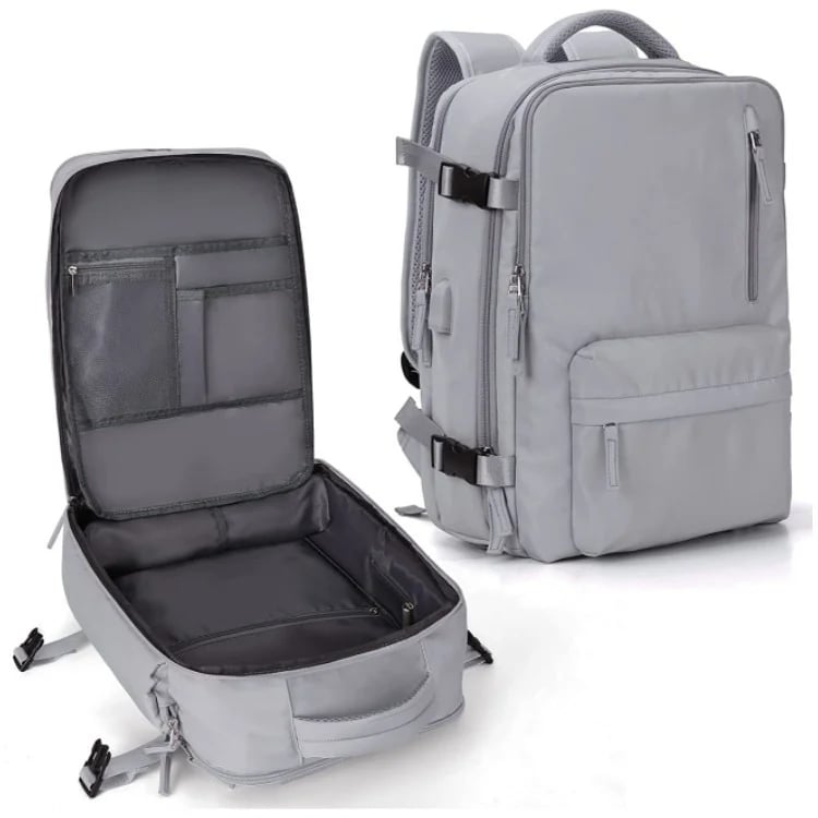 Grey waterproof travel backpack showing closed exterior and open interior with organized storage pockets and USB port.