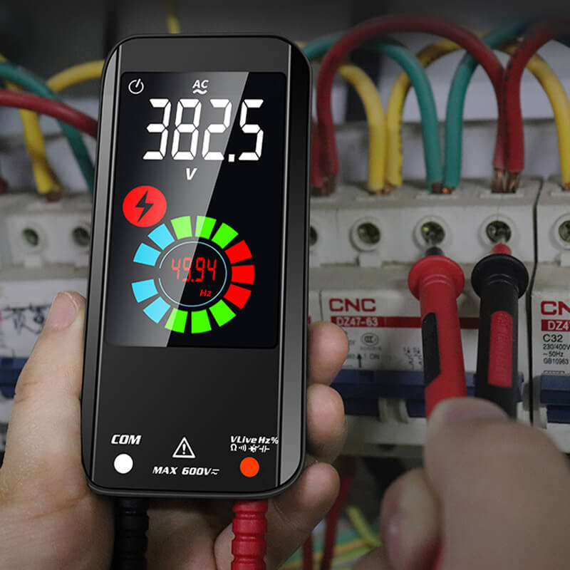 Fitlybuy smart digital multimeter showing AC voltage testing on an electrical circuit breaker panel.