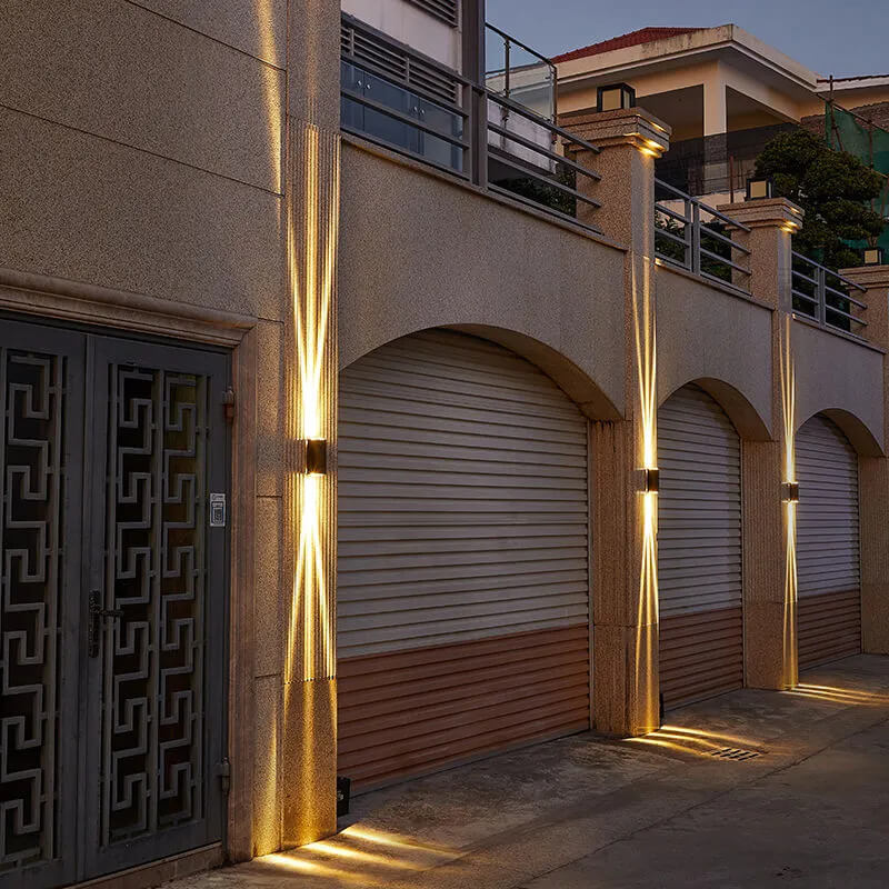 Fitlybuy rectangular waterproof LED outdoor wall lights mounted on building pillars, casting upward and downward light.