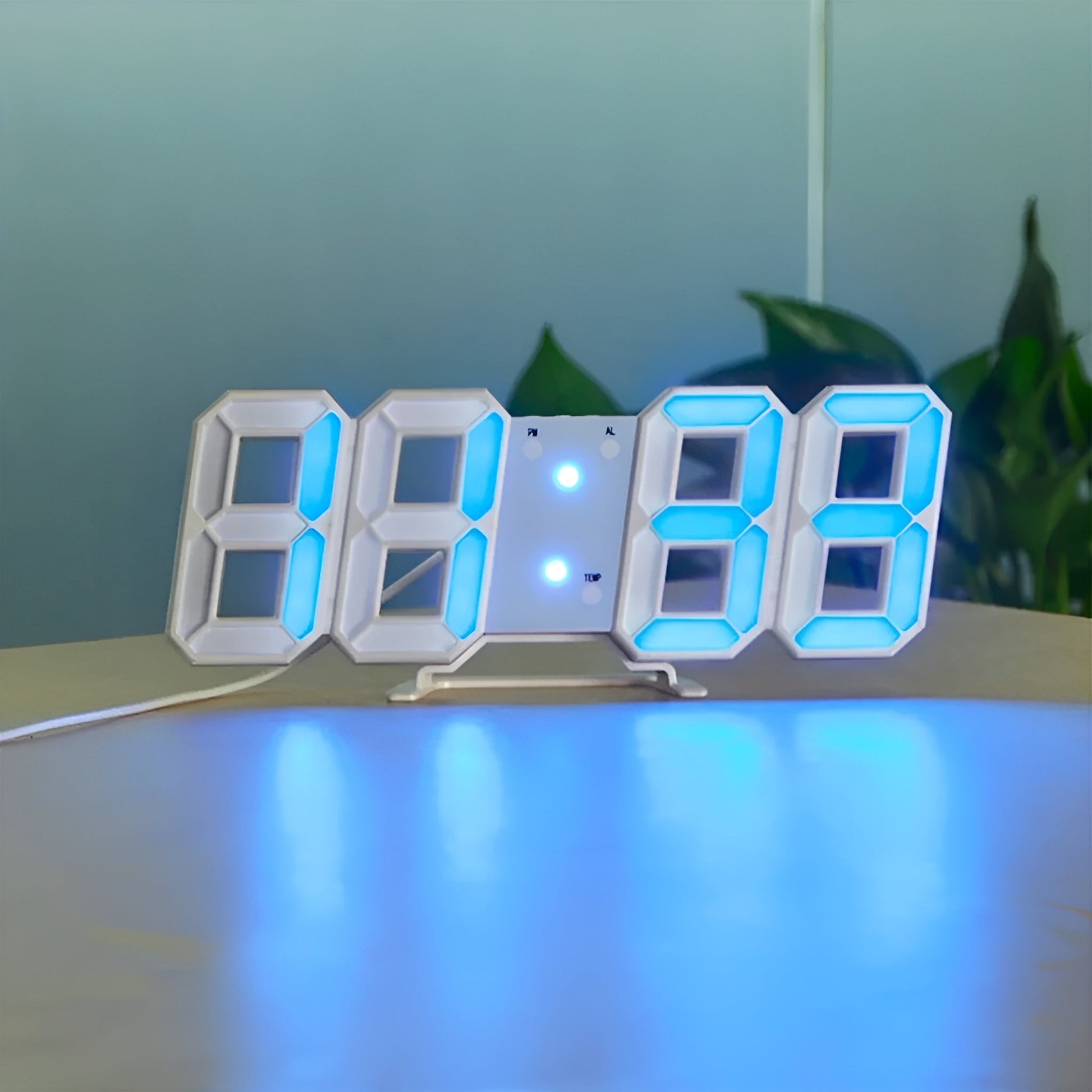 White 3D LED digital desk clock with bright blue light-up numbers, temperature, and alarm on a table.
