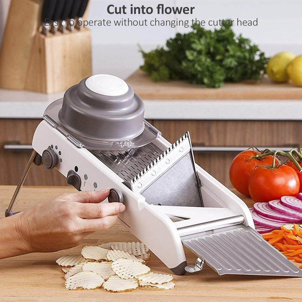 Fitlybuy adjustable white mandoline slicer with stainless steel blades being used to slice vegetables on a kitchen counter.