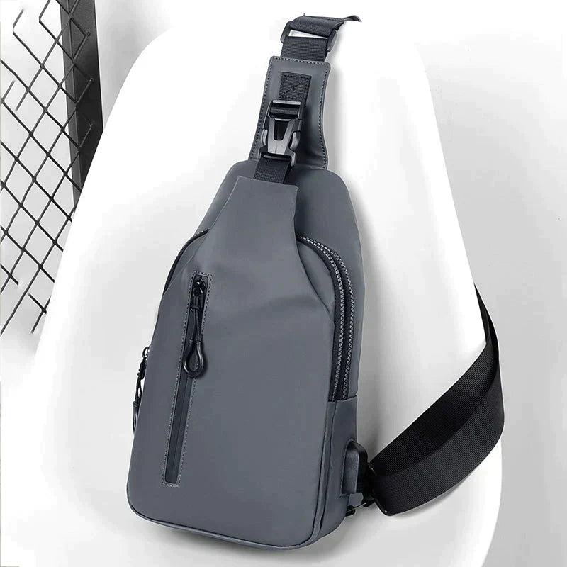 Grey Fitlybuy waterproof anti-theft crossbody bag with black buckle strap, side zipper, and SecureLock technology.