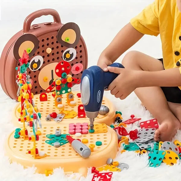 Child uses a blue toy drill on a Fitlybuy WonderBuild bear-shaped Montessori STEM toy board with colorful parts.