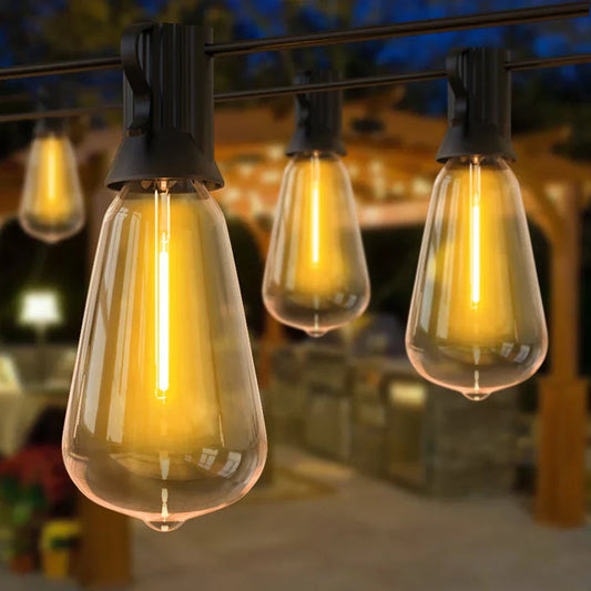 Fitlybuy weatherproof LED string lights with warm, glowing Edison-style bulbs, hanging in a cozy outdoor patio setting.