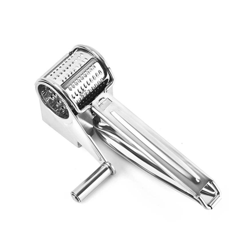 Stainless steel rotary cheese grater with a manual crank handle and textured grating drum on a plain white background.