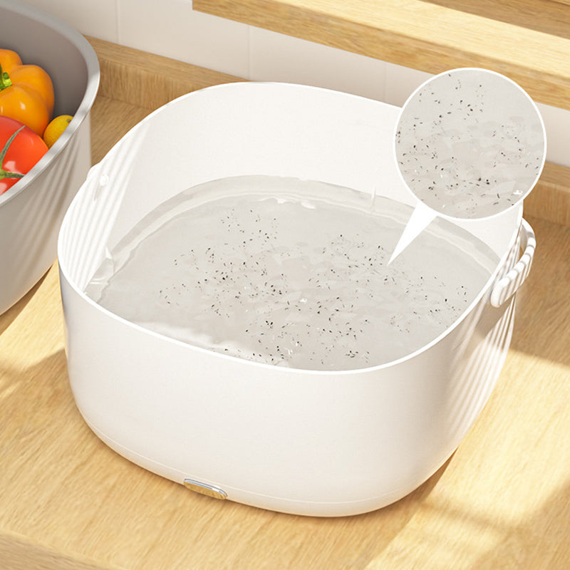 White FreshWave ultrasonic vegetable cleaner with water and debris visible in a kitchen close-up.