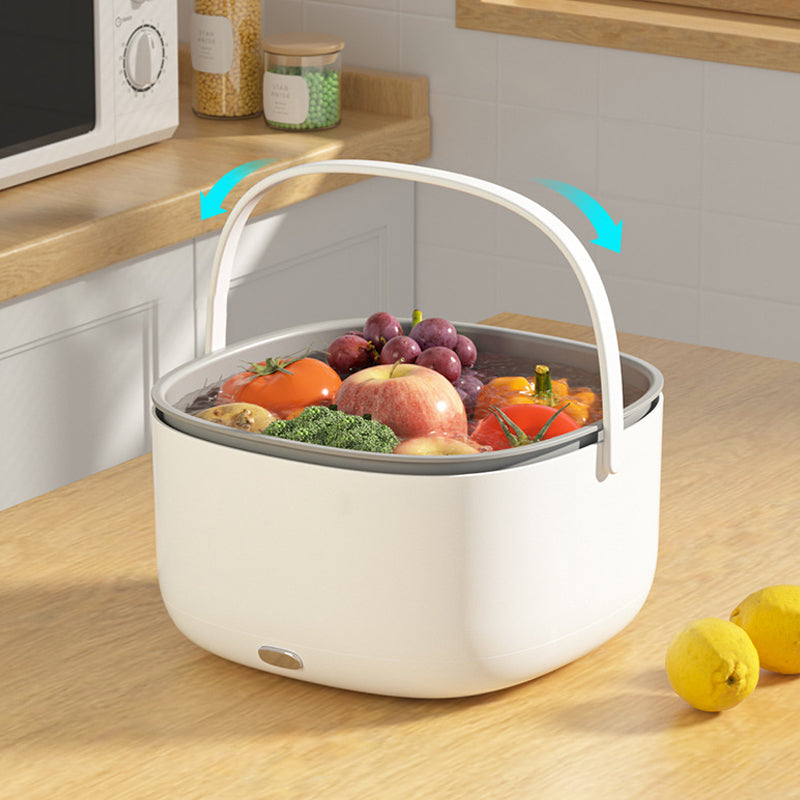Fitlybuy FreshWave white ultrasonic cleaner with a handle, washing fruits and vegetables on a kitchen counter.