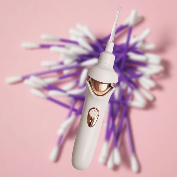 Fitlybuy painless ear wax removal kit with white and rose gold handle, over a background of purple cotton swabs.