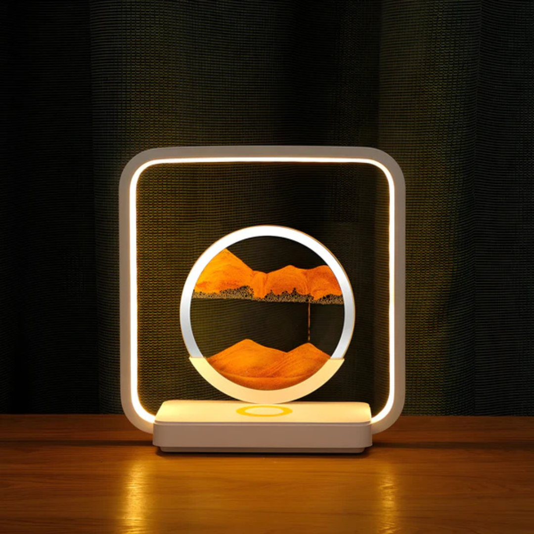 Fitlybuy SandAura 3D LED lamp with a circular orange sand art display in a square white frame on a wooden table.