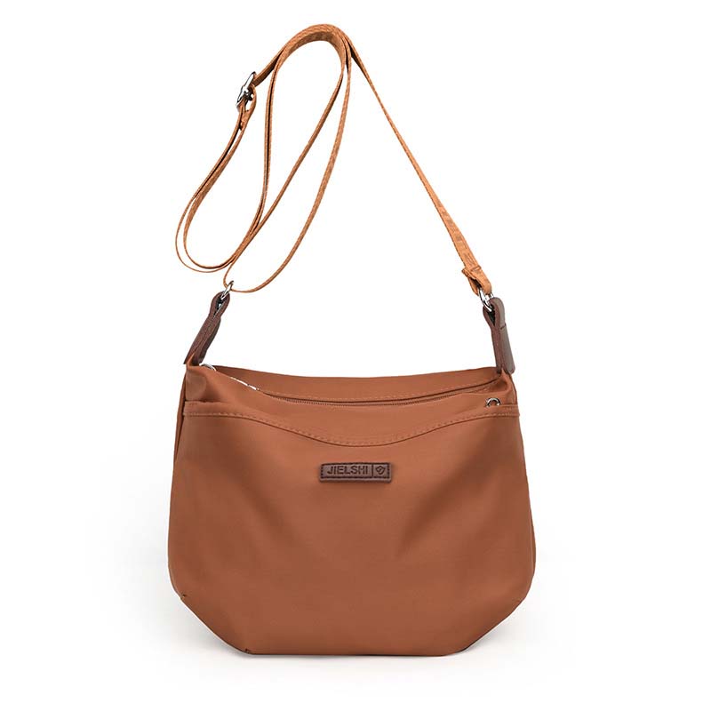 Brown waterproof Joanna anti-theft crossbody bag with an adjustable strap and zip closure on a plain white background.
