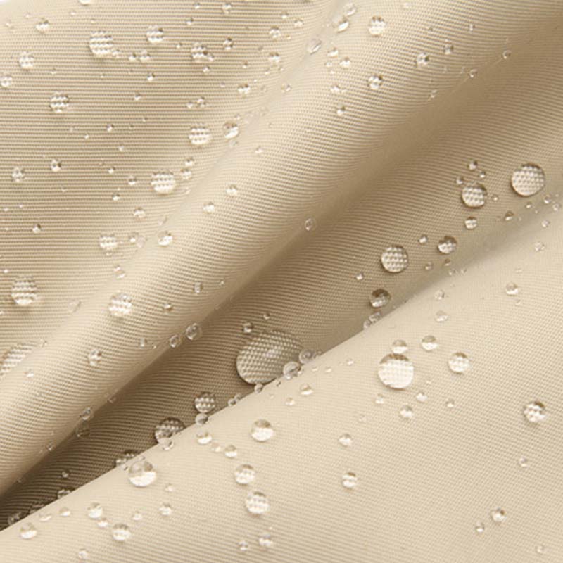 Close-up of beige, waterproof fabric for Fitlybuy Joanna shoulder bag, showing water droplets beaded on the surface.