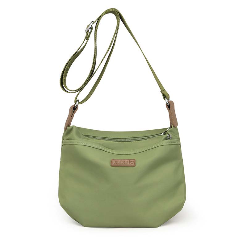Olive green anti-theft crossbody bag with adjustable strap, zipper top, and Jielshi brand tag on a white background.