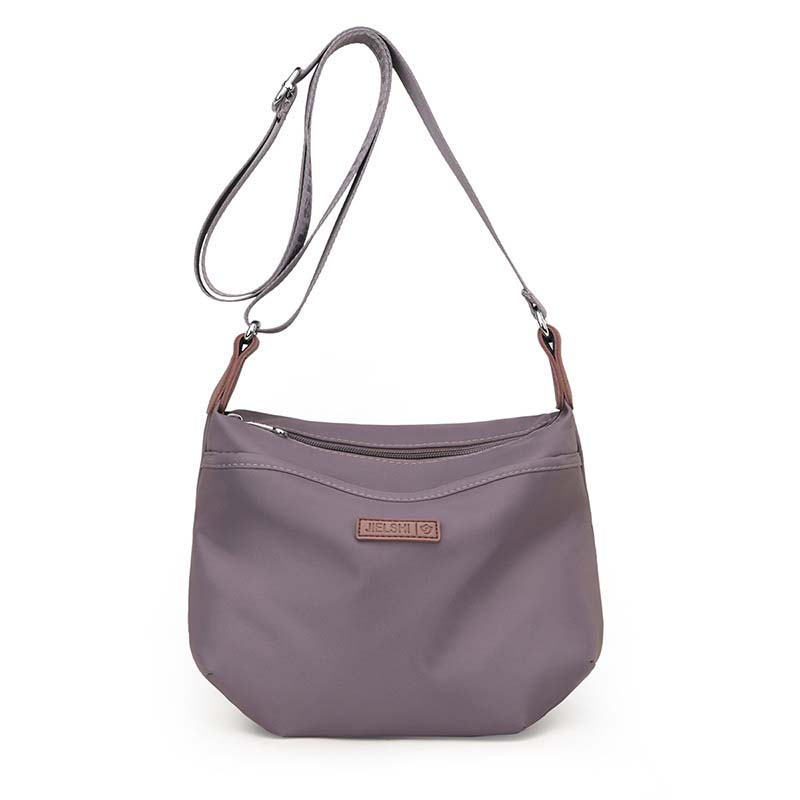 Purple Fitlybuy Joanna anti-theft waterproof crossbody bag with an adjustable strap and front zipper pocket.