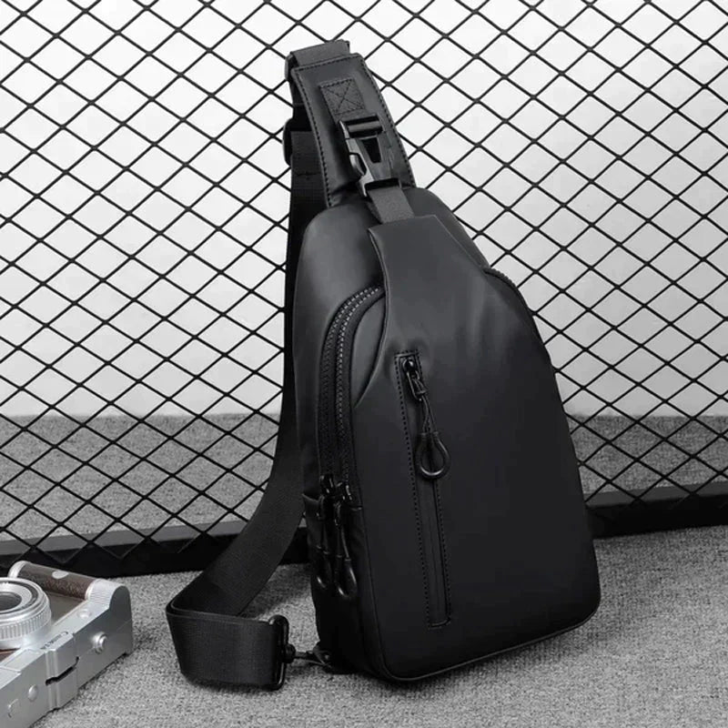 Fitlybuy black waterproof anti-theft crossbody bag with secure lock, shown against a black wire grid background.