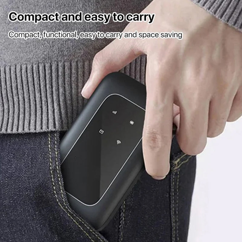Hand holds a compact, black Fitlybuy WiFi Pro booster, sliding it into a denim pocket to show its portable design.