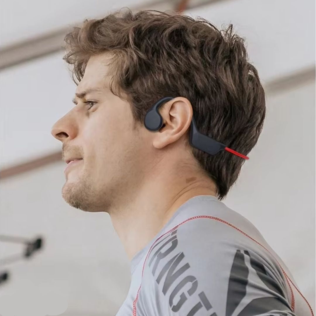 Man wearing black Fitlybuy bone conduction headphones while active. Lightweight, open-ear design for sports and cycling.
