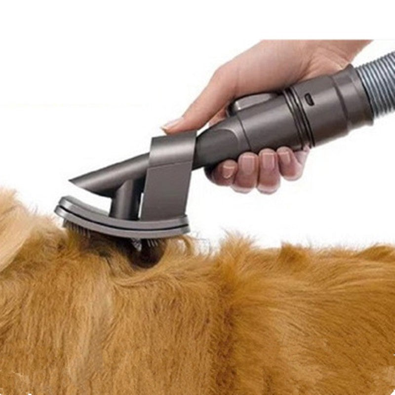 Grey Fitlybuy dog and cat vacuum grooming brush attachment being used to brush golden-brown pet fur.
