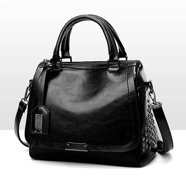 Elegant black soft leather shoulder bag with a top handle, shoulder strap, metal hardware, and side studded accents.