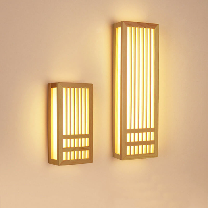 Two Japanese-style wooden LED wall lamps in varying sizes emit a warm, ambient ZenGlow on a beige wall.