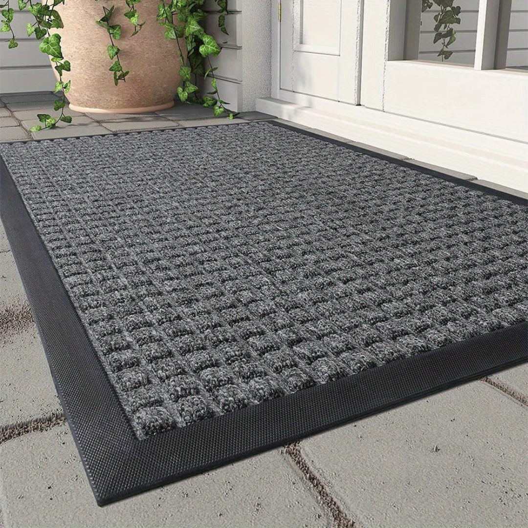 Fitlybuy grey rectangular door mat with textured dirt-trap pattern and black border at an entryway.