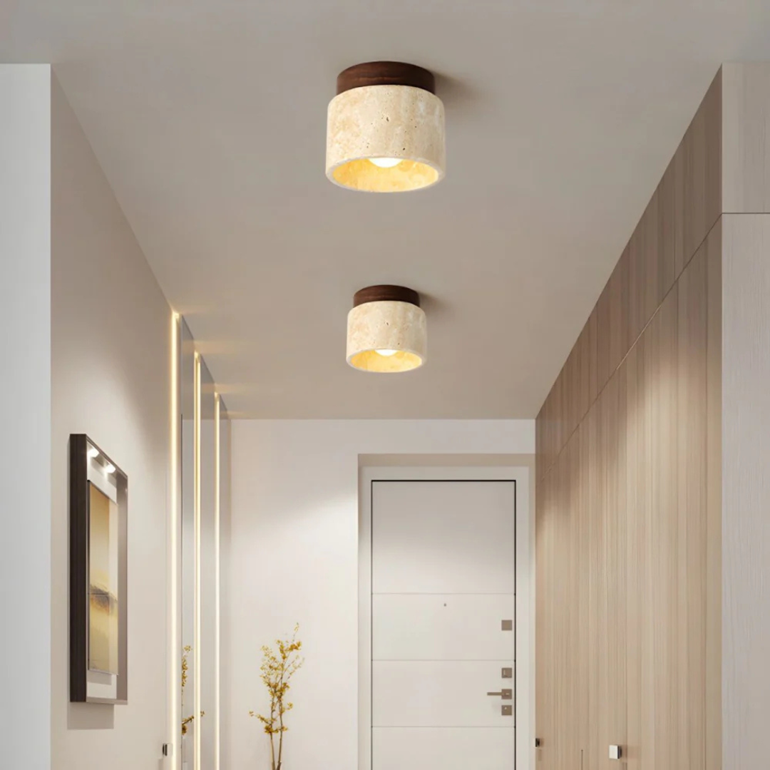 Fitlybuy Radia minimalist ceiling lights with beige stone shades and dark wood mounts emitting a warm glow in a hallway.