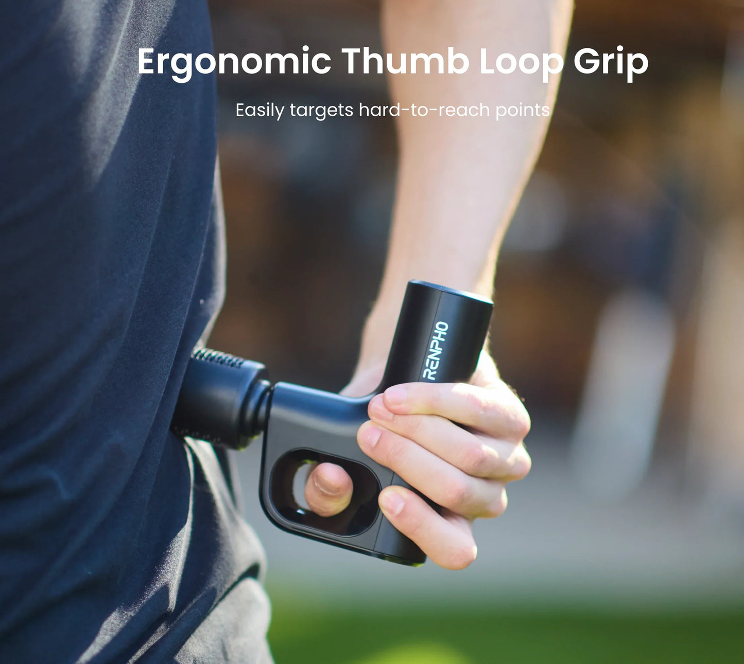 A person uses a compact black Fitlybuy Active Mini massage gun with a thumb loop grip for ergonomic back massage.