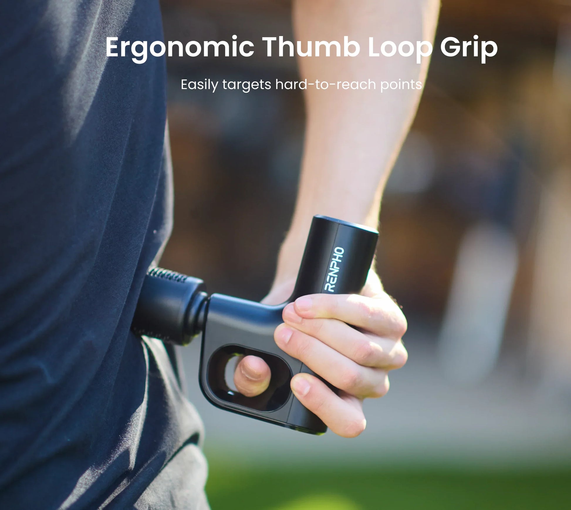 A person uses a compact black Fitlybuy Active Mini massage gun with a thumb loop grip for ergonomic back massage.
