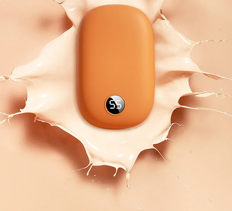 Orange Fitlybuy 2-in-1 hand warmer and power bank with a digital temperature display on a liquid splash background.