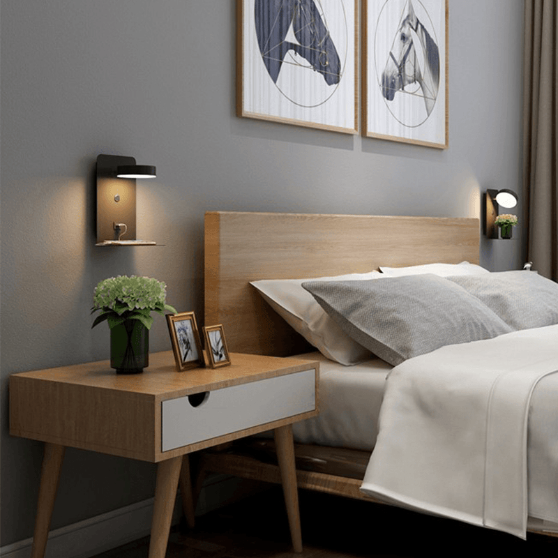 Black wall-mounted Fitlybuy BrightSpot lamp with 330° rotating LED and USB charging shelf above a wooden nightstand.
