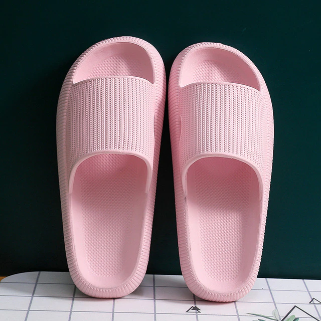 Fitlybuy light pink cloud slippers with textured memory foam, shown against a dark backdrop on a grid surface.