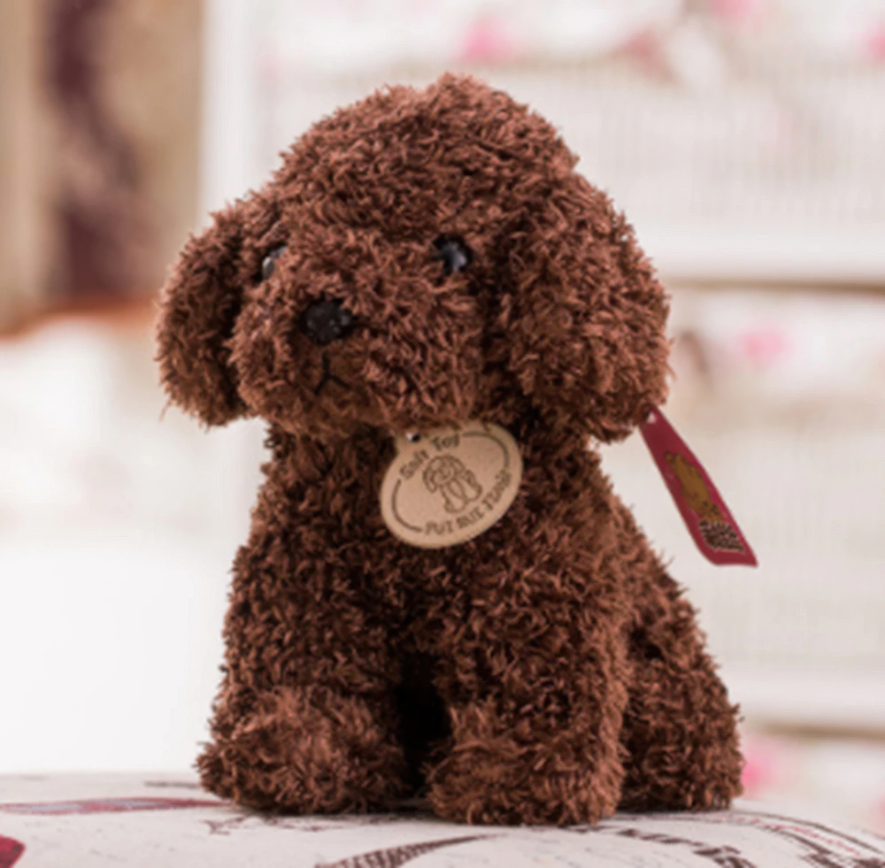 Fitlybuy brown, curly-haired plush teddy dog toy with a round tag, sitting on a soft surface.