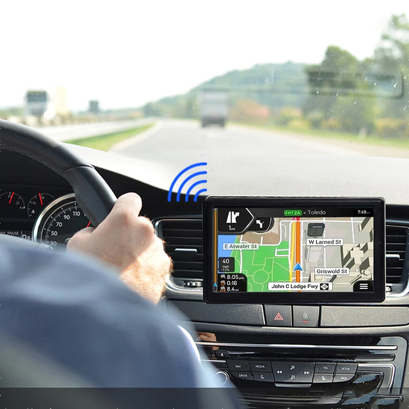 Fitlybuy 7-inch truck GPS navigation mounted on a dashboard, displaying city map routes while a driver steers.