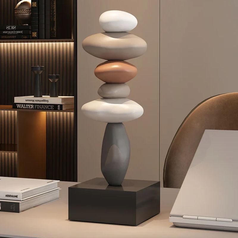 Fitlybuy Balanture stacked stone sculpture with multi-colored smooth pebbles on a black base, set in a modern office.