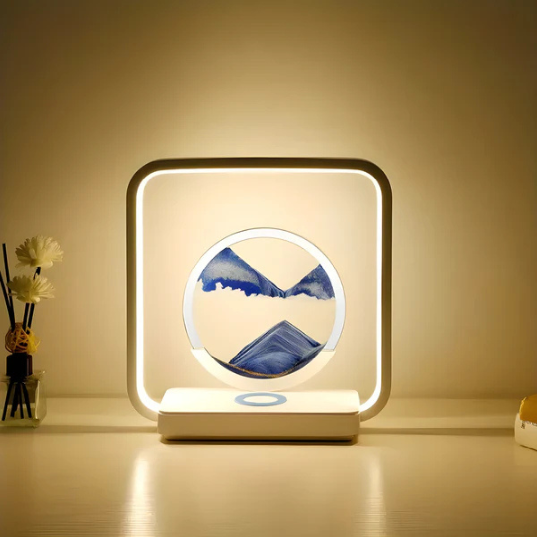 Fitlybuy SandAura square LED lamp with circular blue flowing sand art display, glowing warmly on a white tabletop.
