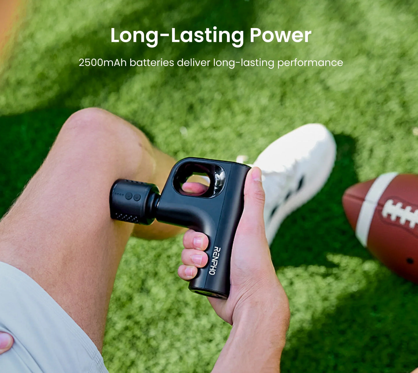 Black Fitlybuy Active Mini massage gun with heat therapy being used on a leg over green turf.