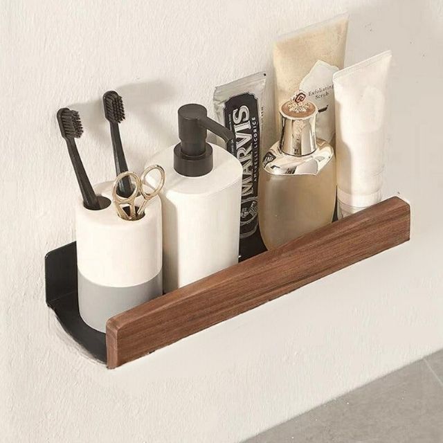 Fitlybuy solid wood and black metal bathroom shelf holding toiletries, toothbrushes, and soap on a white wall.