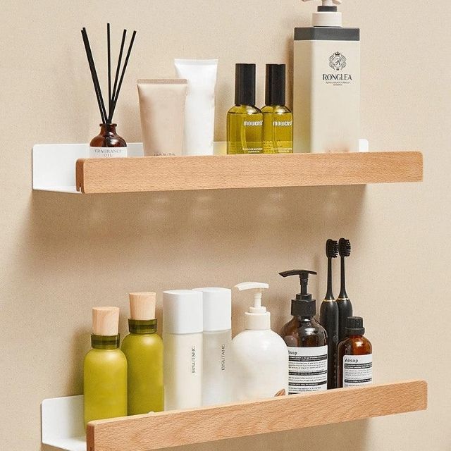 Fitlybuy solid wood bathroom shelves with white wall-mounted brackets, holding various toiletries and skincare bottles.