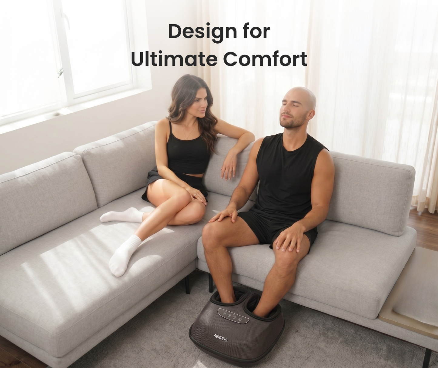 A man relaxes on a couch using a gray Fitlybuy Solheel electric foot massager with ComfortWave tech.
