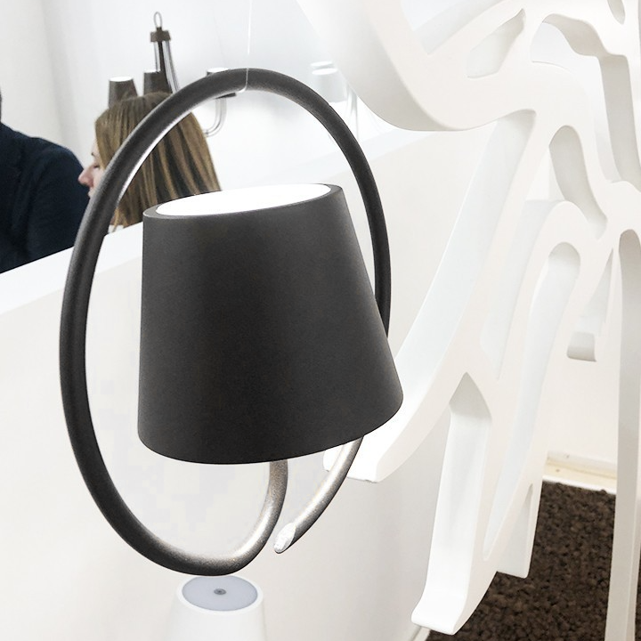 Fitlybuy LumiCord wireless hanging LED lamp with a matte black shade inside a circular frame, set in a modern display.