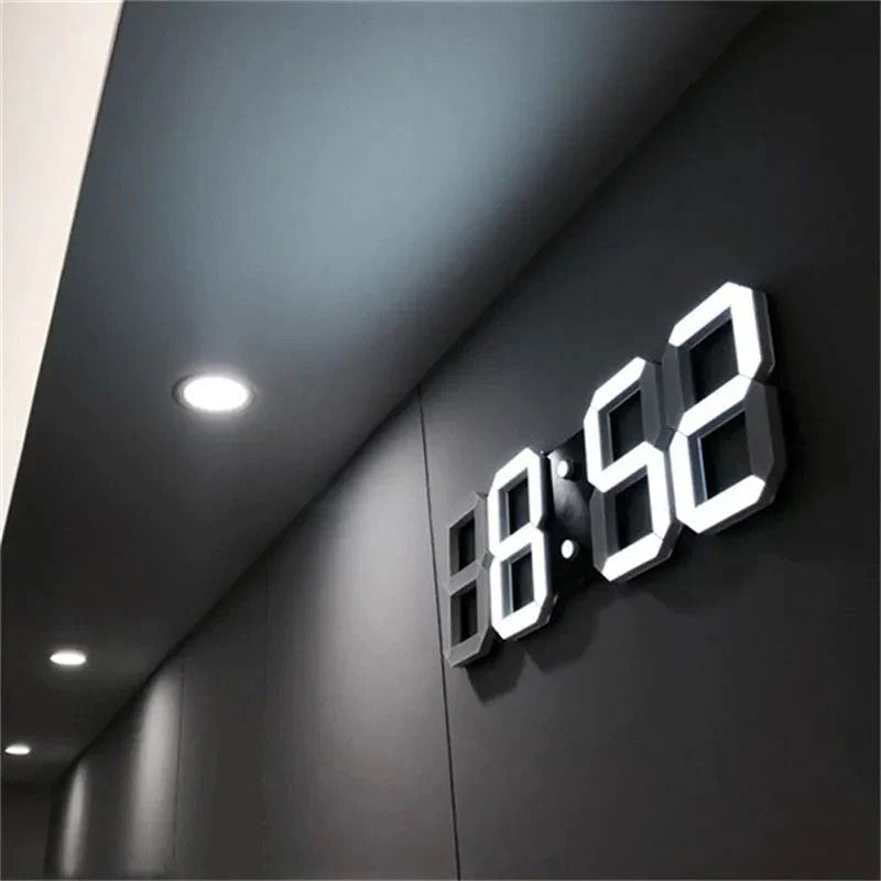 Fitlybuy PixelTime 3D LED digital wall clock showing time in bright white on a sleek, dark modern wall.