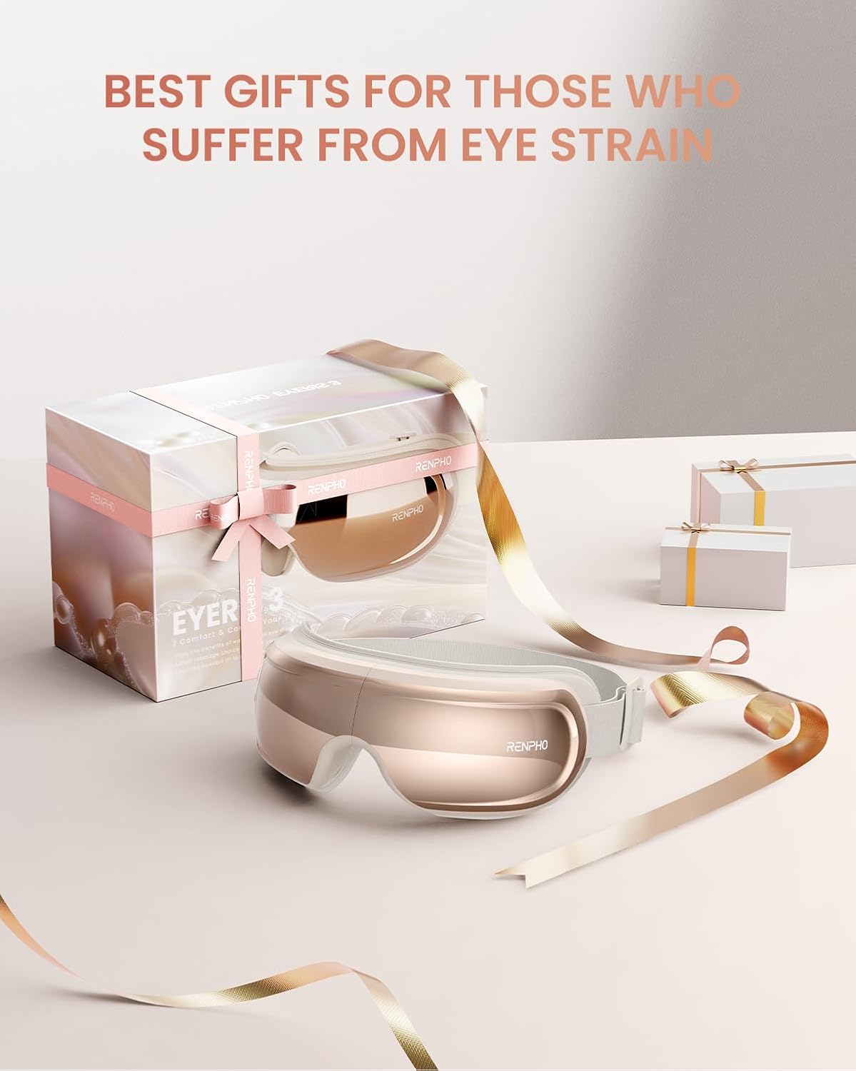 Rose gold Renpho Eyeris 3 eye massager with heat and vibration, shown in gift packaging with ribbons.