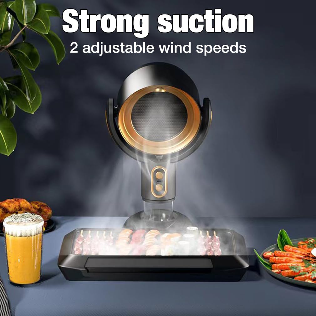 Black Fitlybuy portable range hood with gold trim, capturing smoke from a tabletop grill on a dining table.