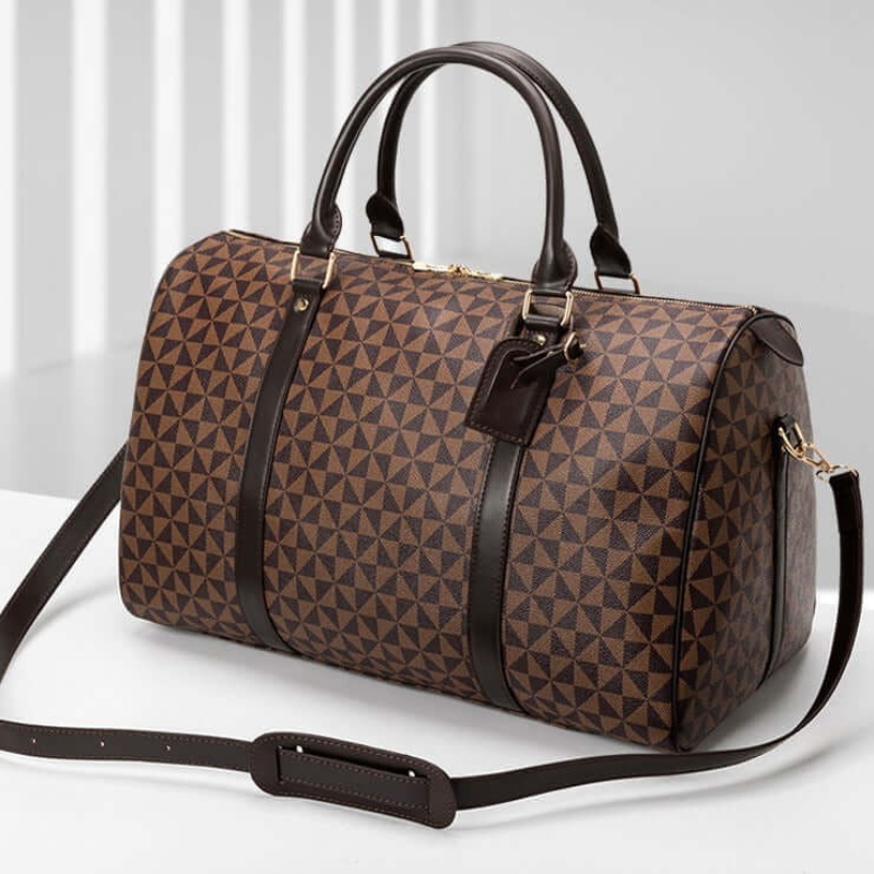 Fitlybuy Westman unisex brown travel duffle with a geometric triangle pattern, leather trim, and adjustable strap.