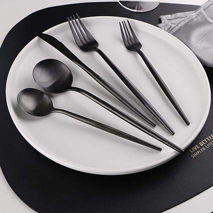 Fitlybuy Torin 36-piece stainless steel cutlery set with a minimalist matte black finish on a white dinner plate.