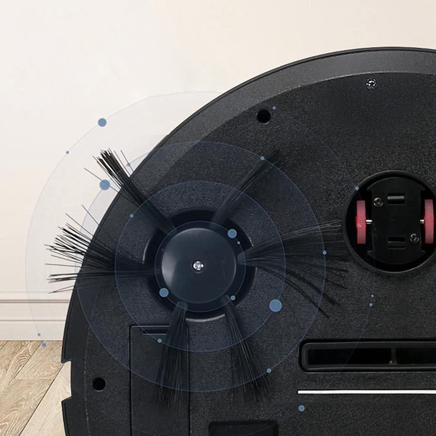 Fitlybuy AutoSweep robot vacuum underside, showing black spinning brushes and navigation sensors on a wood floor.