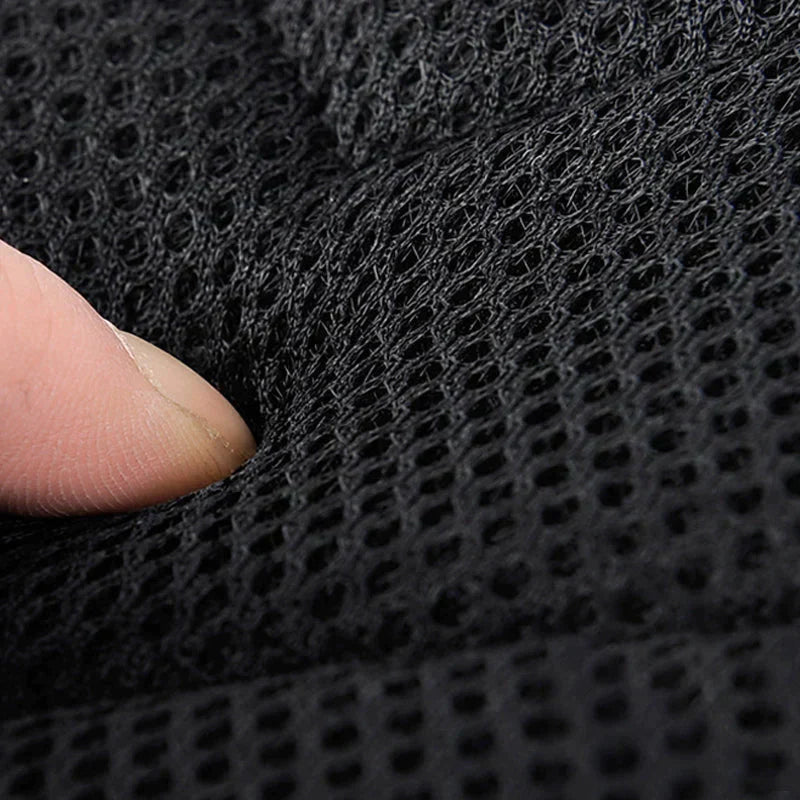 Finger presses into the black, cushioned mesh padding of a Fitlybuy waterproof anti-theft crossbody bag.