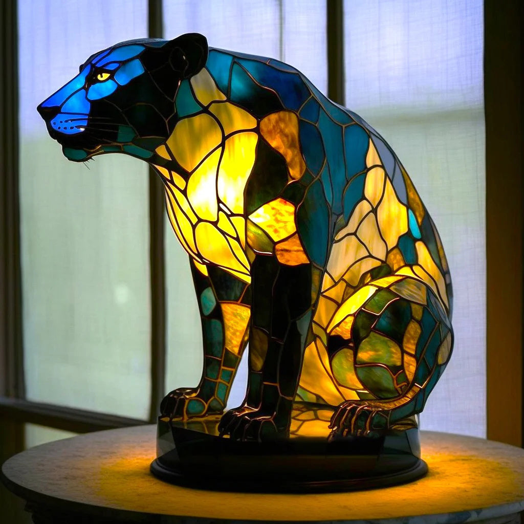 Stained glass panther lamp in blue and amber, featuring a handmade, art-inspired design emitting an ambient inner glow.