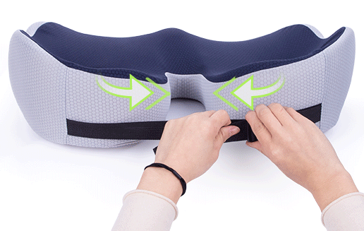 Fitlybuy ergonomic sciatica relief cushion in blue and grey being secured by hands with an adjustable strap.